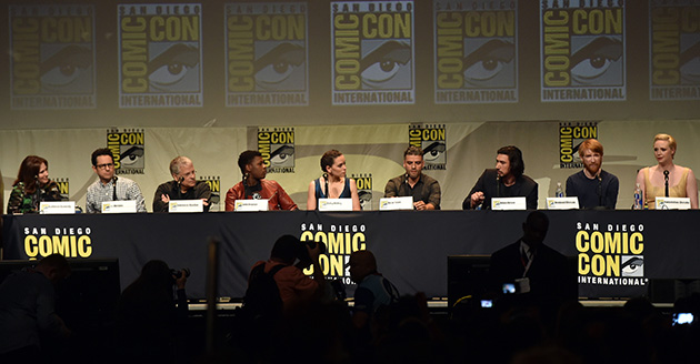 SAN DIEGO, CA - JULY 10:  (L-R) Producer Kathleen Kennedy, director J.J. Abrams, screenwriter Lawrence Kasdan, actors John Boyega, Daisy Ridley, Oscar Isaac, Adam Driver, Domhnall Gleeson, and Gwendoline Christie speak onstage at the Lucasfilm panel during Comic-Con International 2015 at the San Diego Convention Center on July 10, 2015 in San Diego, California.  (Photo by Kevin Winter/Getty Images)